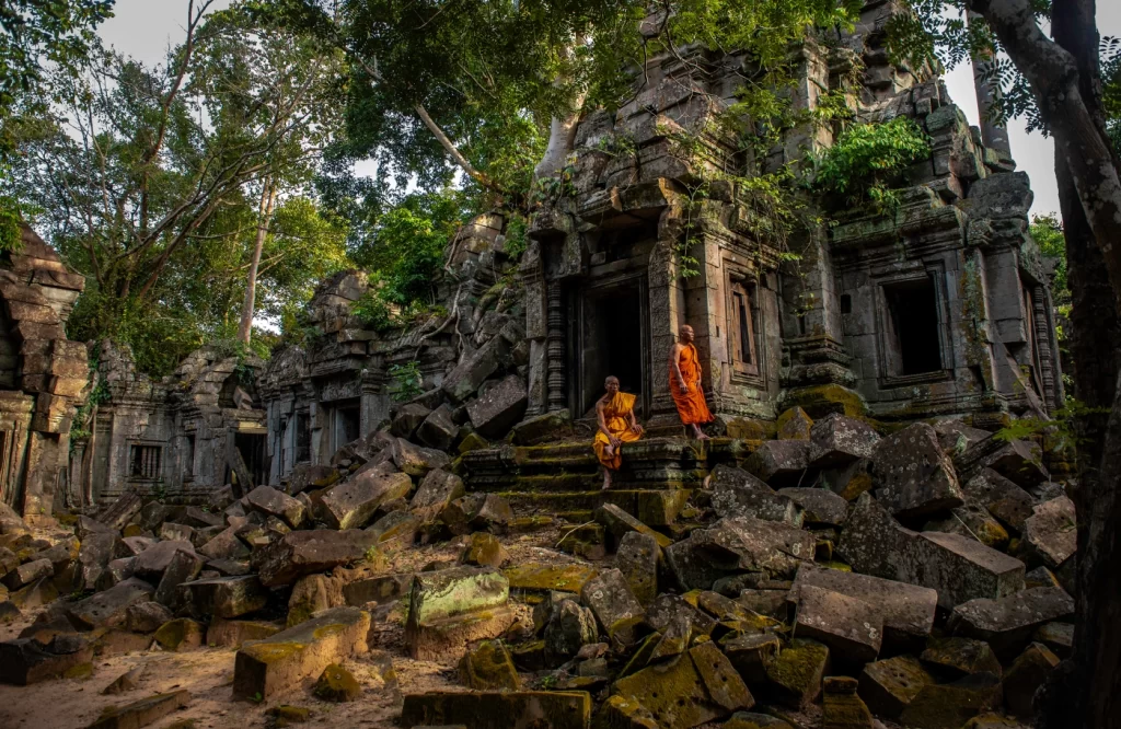 Holly monks explore around ruined Temple of banteay Ampil.